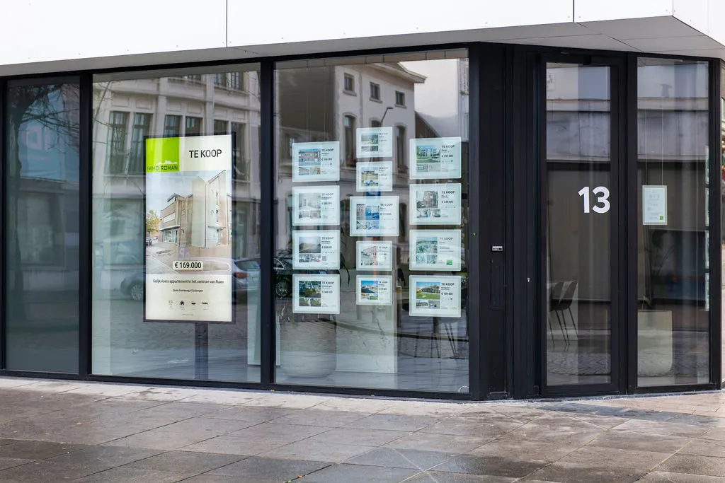 The Immo Roman corner office at number 13, with a screen next to the posters